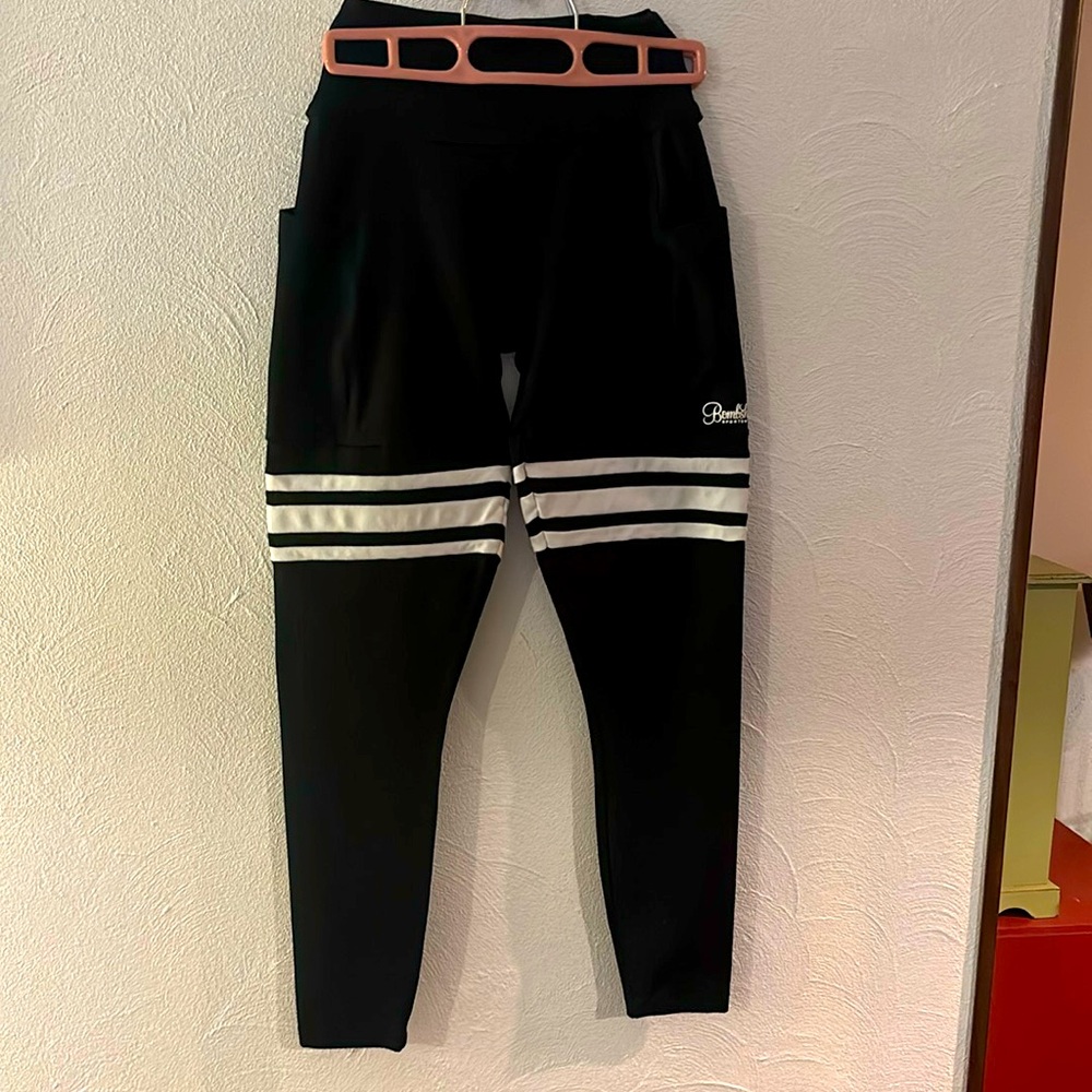 Bombshell workout leggings, like new.  Black with white stripes.